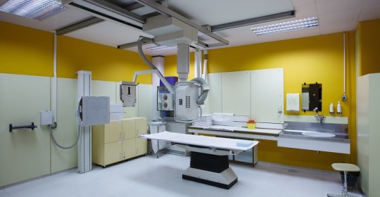 X-ray room in a hospital ER operating room with a classic ceiling-mounted x-ray system. Modern medical equipment interventional medicine and healthcare concept.